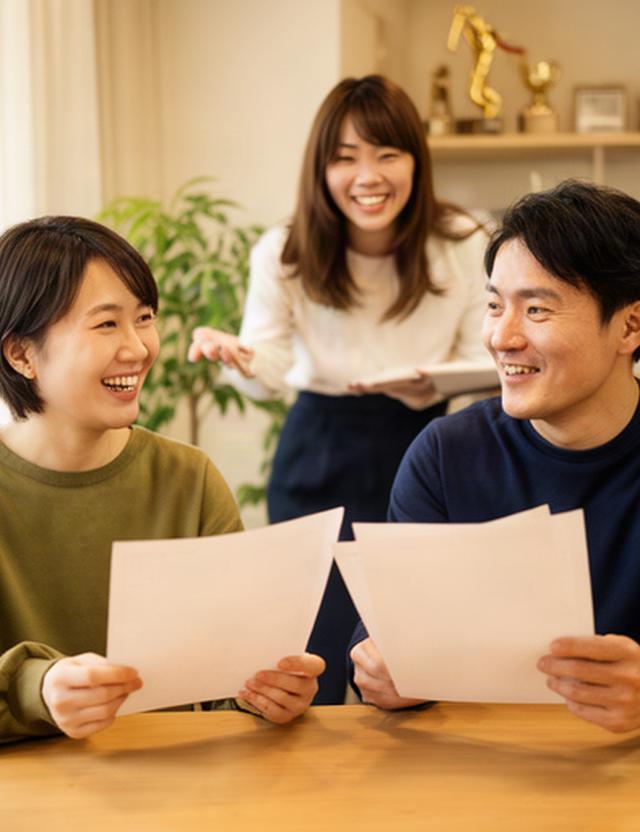 名古屋の相談室で家計改善の資料を手に笑顔で話す夫婦